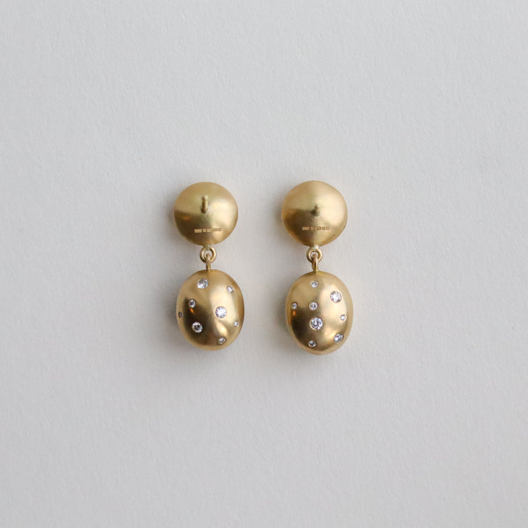 Statement 18ct yellow gold diamond set earrings featuring a smooth bezel setting, back speckled with diamonds back view paper shots