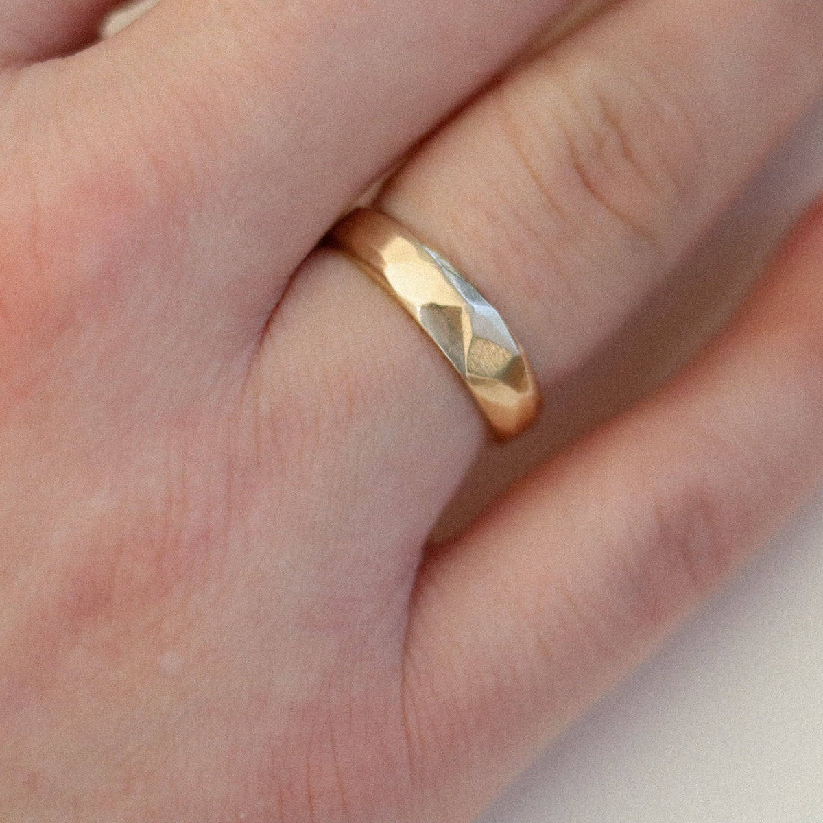 gold band on hand, hand-made facetted style unisex design