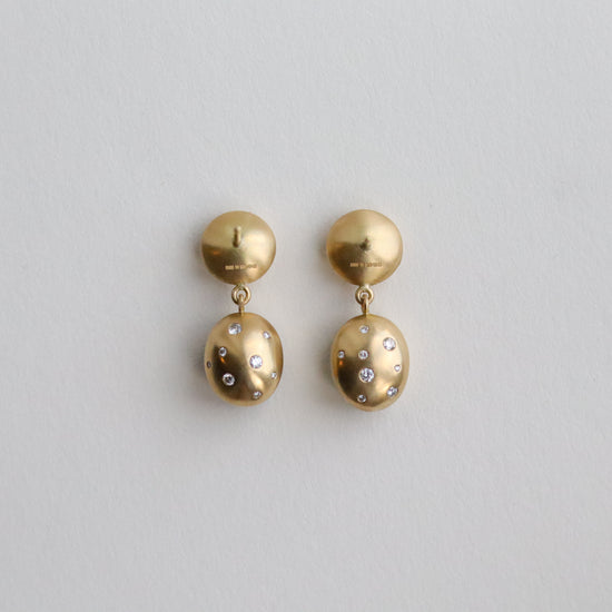Statement 18ct yellow gold diamond set earrings featuring a smooth bezel setting, back speckled with diamonds back view paper shots