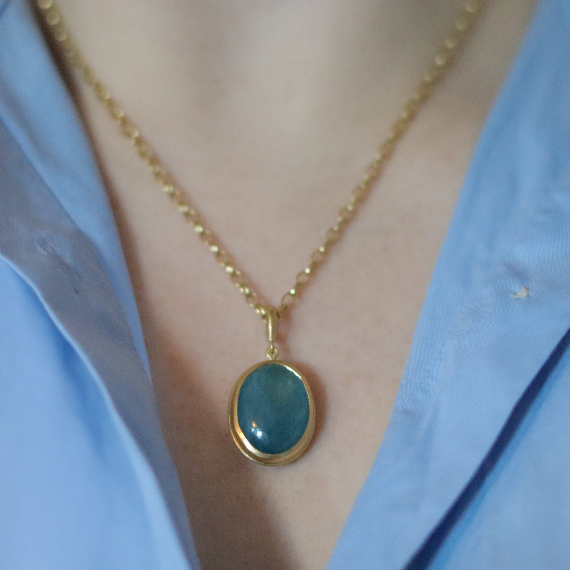 Goldfinch jewellery 18ct yellow gold aquamarine cabochon brushed gold egg shaped oval domed pendant on belcher chain on model