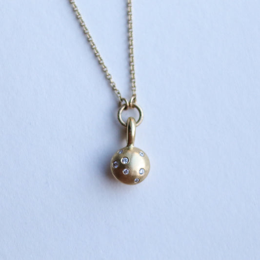 goldfinch jewellery Minimalist solid 18ct yellow gold necklace featuring a brushed gold spherical pendant set with scattered diamonds looped onto a fine solid gold chain