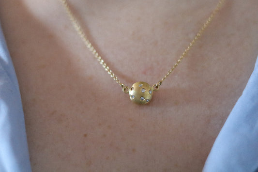 goldfinch jewellery Minimalist solid 18ct yellow gold necklace featuring a brushed gold spherical pendant set with scattered diamonds hung in-line on a fine solid gold chain