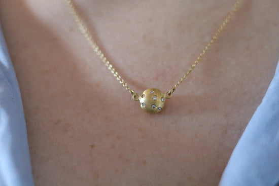 goldfinch jewellery Minimalist solid 18ct yellow gold necklace featuring a brushed gold spherical pendant set with scattered diamonds hung in-line on a fine solid gold chain