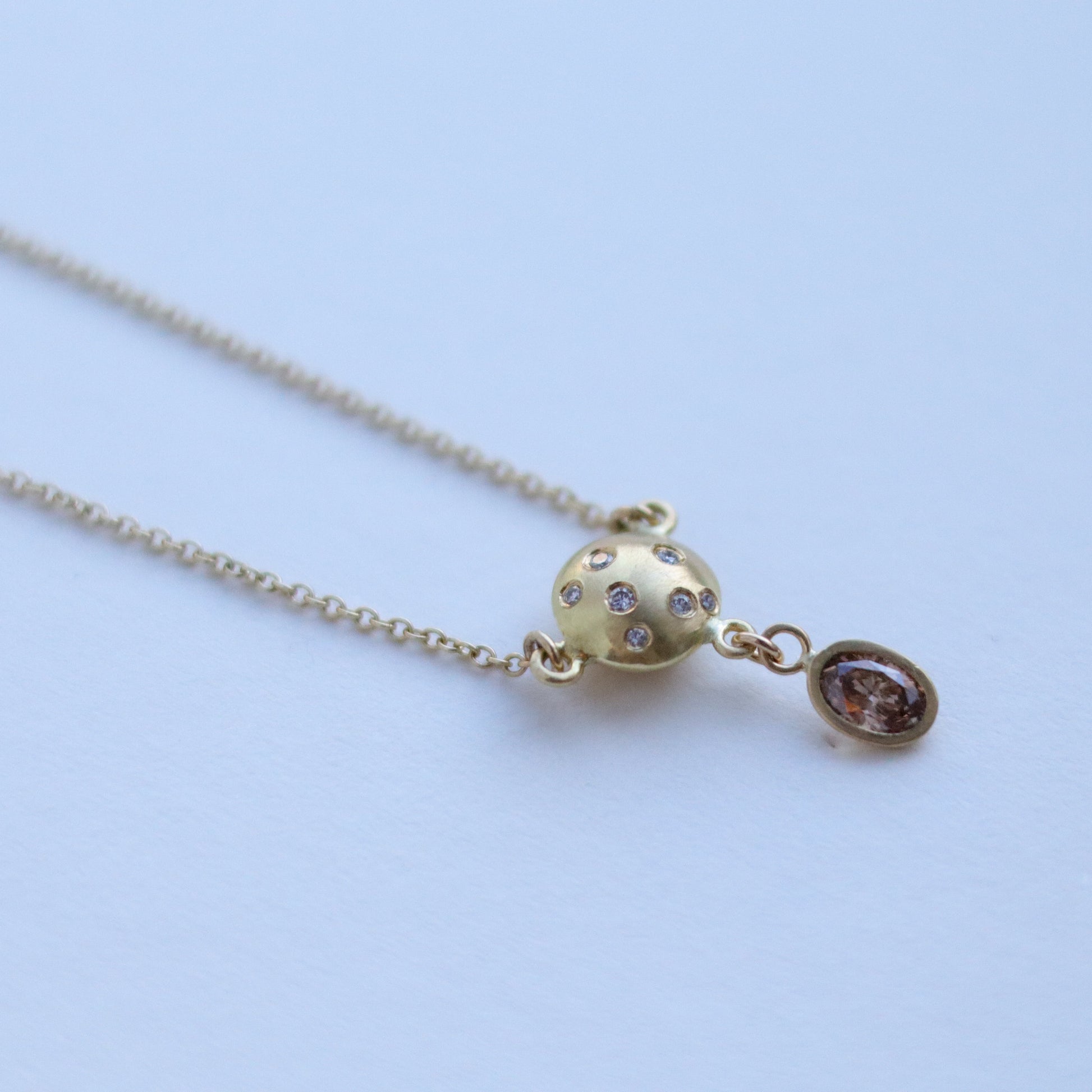 goldfinch jewellery gold sphere pendant necklace set with diamonds, suspended from a delicate gold chain, brown diamond drop. 