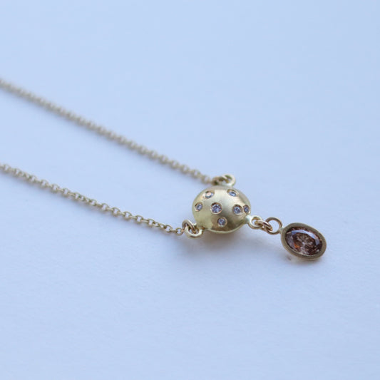 goldfinch jewellery gold sphere pendant necklace set with diamonds, suspended from a delicate gold chain, brown diamond drop. 