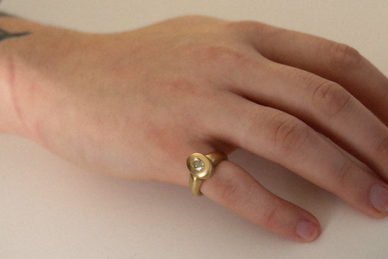 solid heavy 18ct yellow gold curved oval signet ring with oval natural yellow diamond with brushed gold. photographed on mens hand as pinky ring