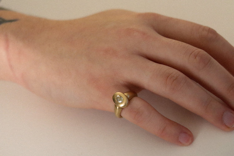 solid heavy 18ct yellow gold curved oval signet ring with oval natural yellow diamond with brushed gold. photographed on mens hand as pinky ring