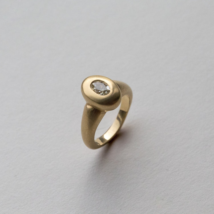 solid heavy 18ct yellow gold curved oval signet ring with oval natural yellow diamond with brushed gold. photographed at perspective angle 